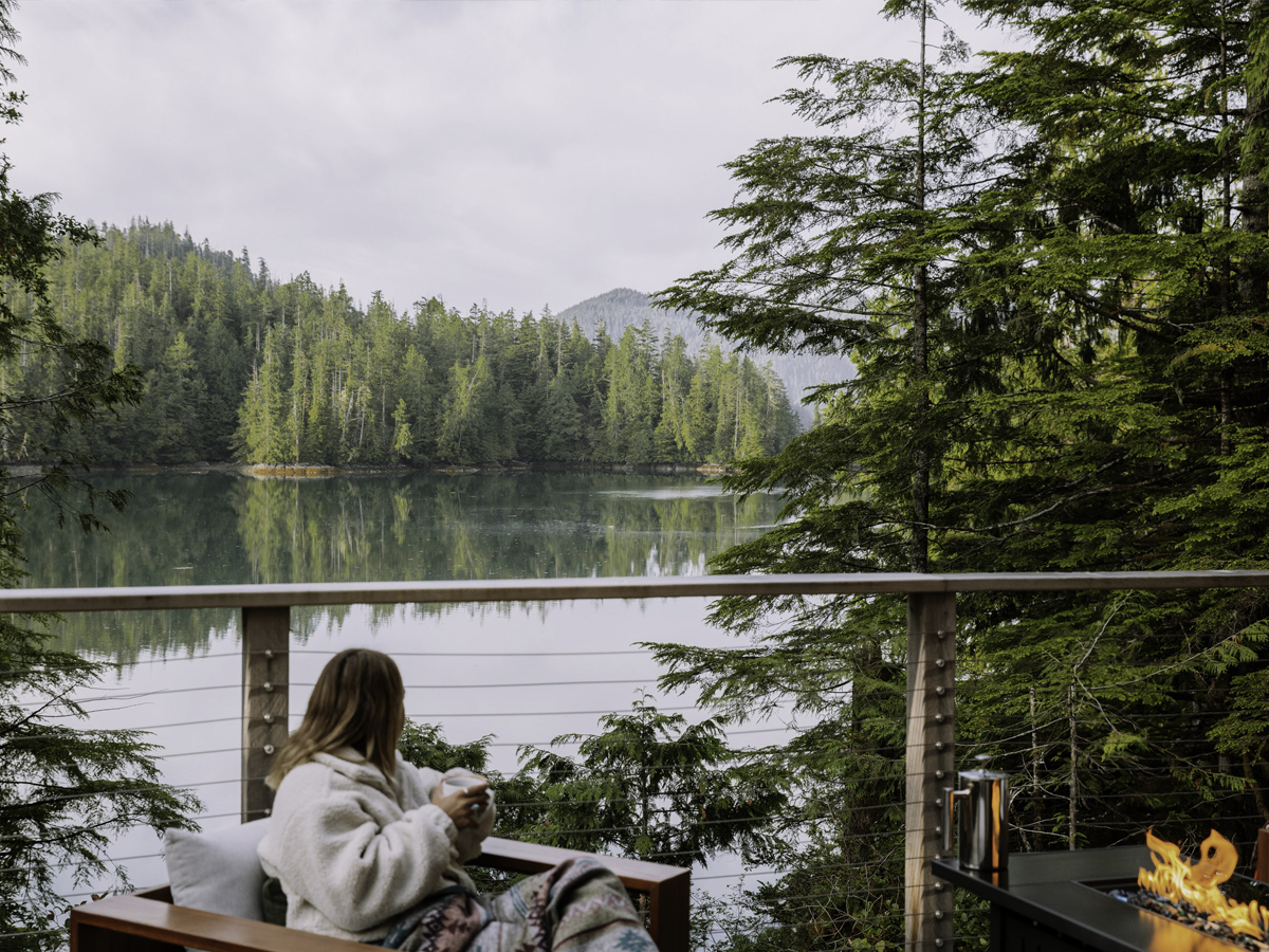 Morning coffee on a deck overlooking the forested cove